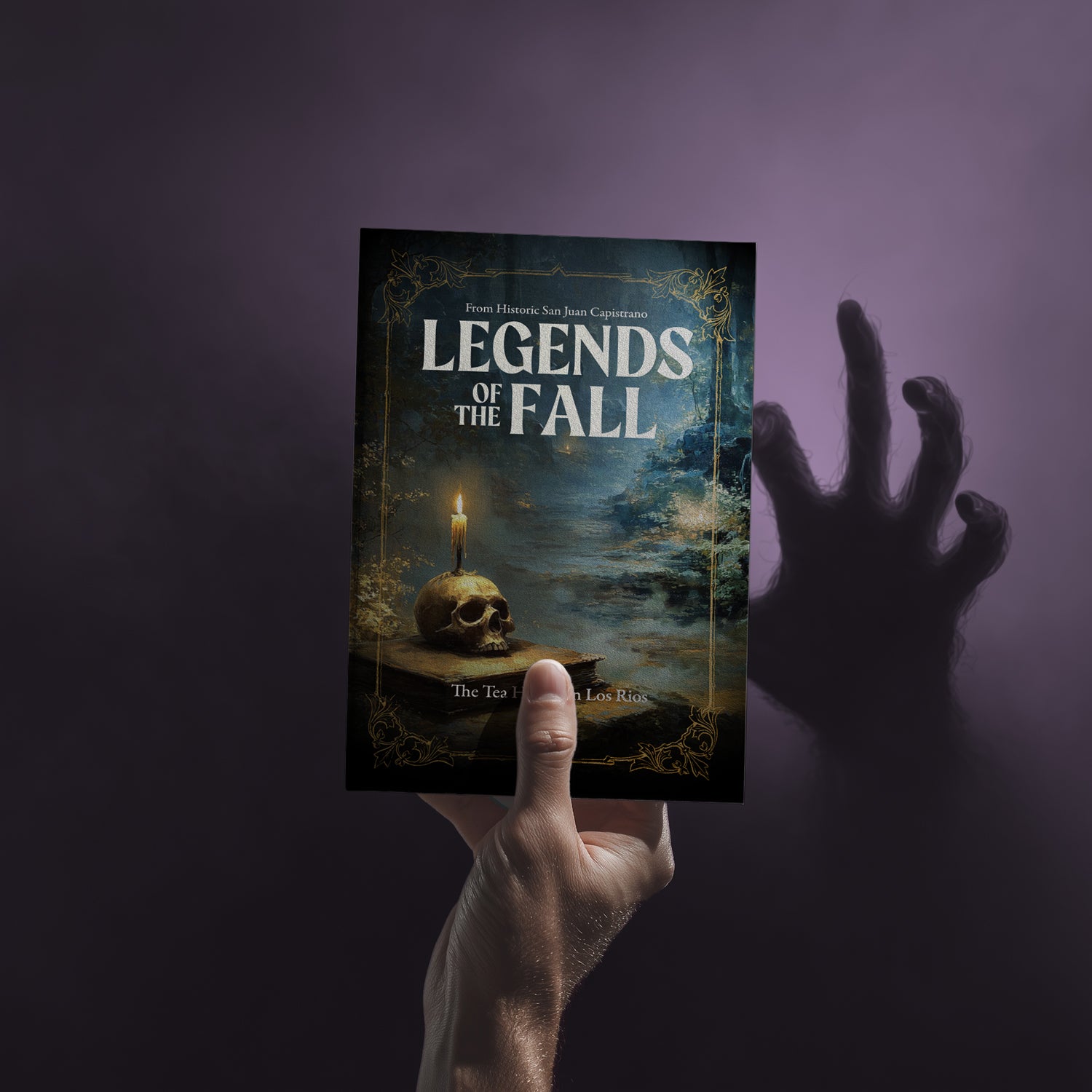 Book titled 'Legends of the Fall' held by a hand against a dark background