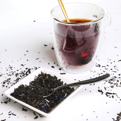 Cream of Earl Grey tea with tea cup and loose tea