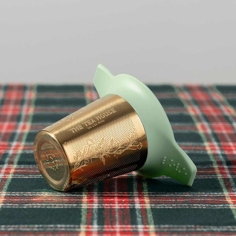 Tea infuser on a plaid fabric background