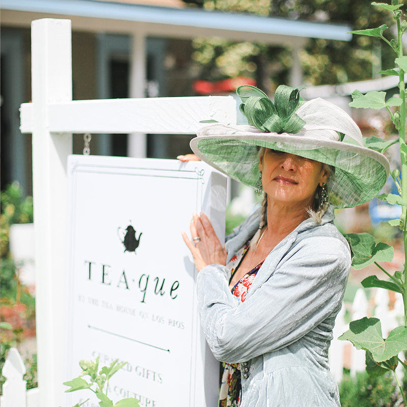 Teaque gift shop sign with beautiful lady wearing a fascinator hat