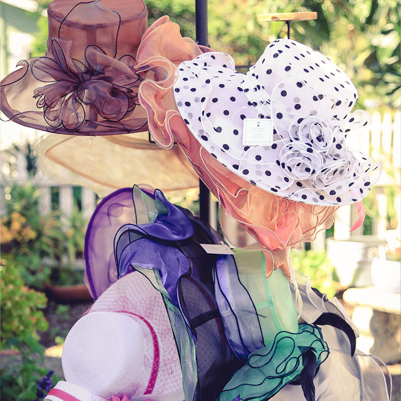 Hat display featuring fancy tea time hats exclusively available at TEAque gift shop