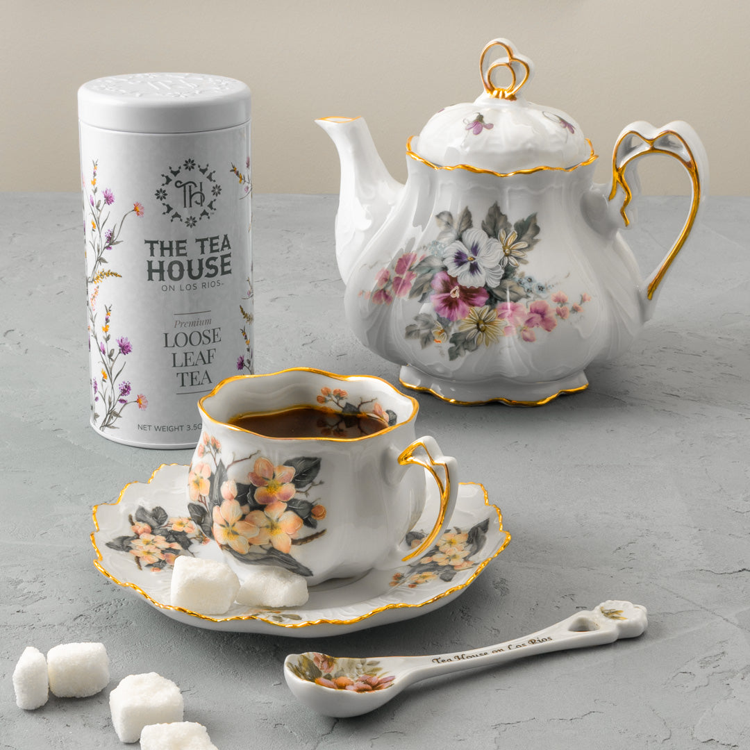 a tin of Tea House on Los Rios loose leaf tea next to a teapot and tea cup.
