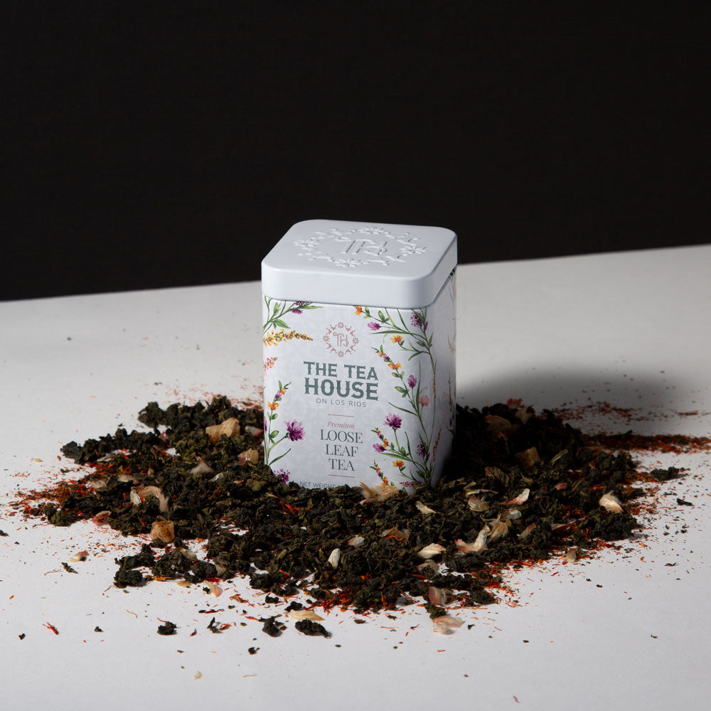 30 gram tea tin with loose leaf tea around it
