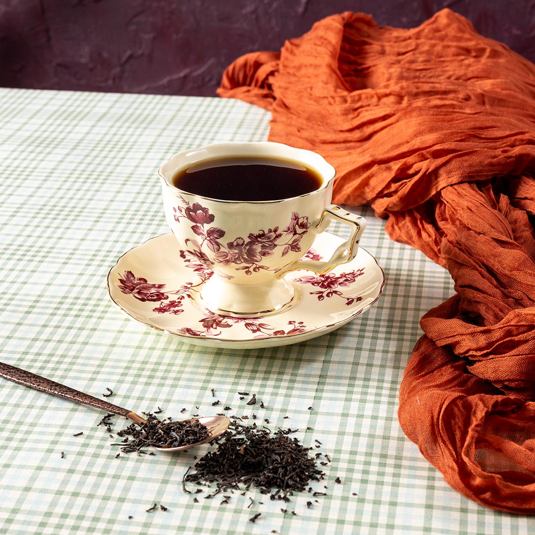 Cup of black tea with loose leaf black tea