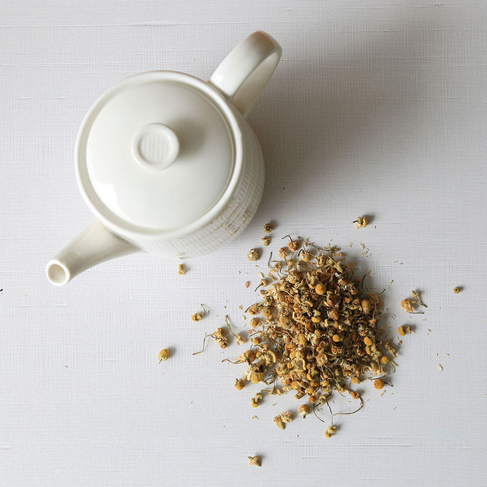 Top view of chamomile tea and teapot