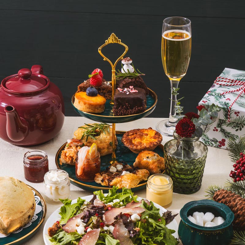 Table setting with festive food, drinks, and decorations on a dark background