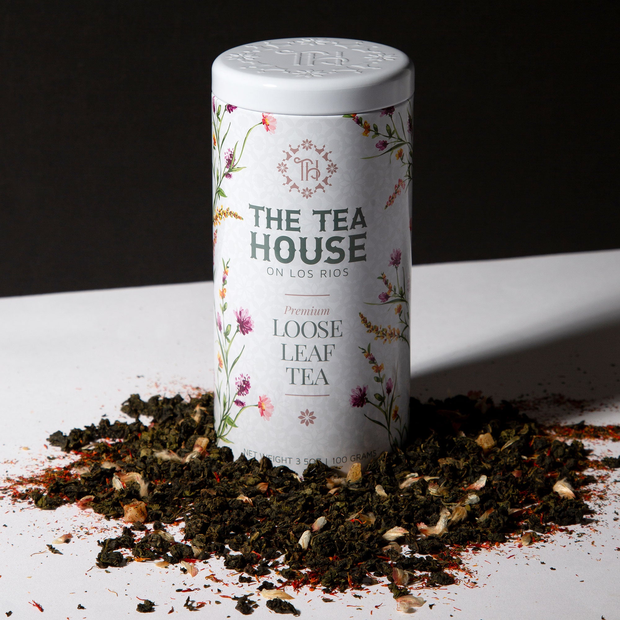 Loose Leaf Tea Tin with Loose Tea around the base of the 100g tin